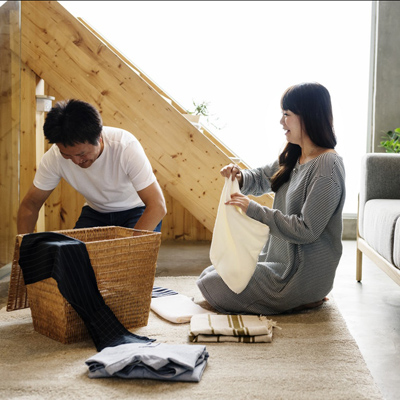 photo of couple putting linens away in their home